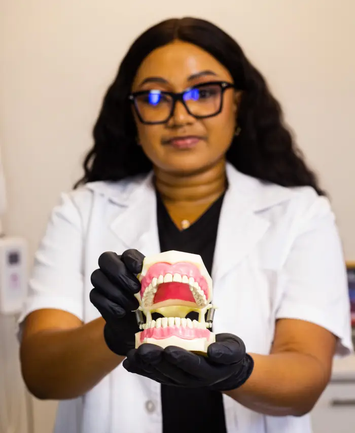 iSmile dentist holding a dental model